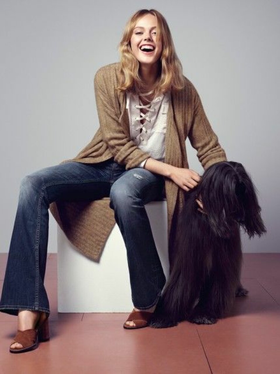 Frida Gustavsson myser med afghanhundar i ny kampanj