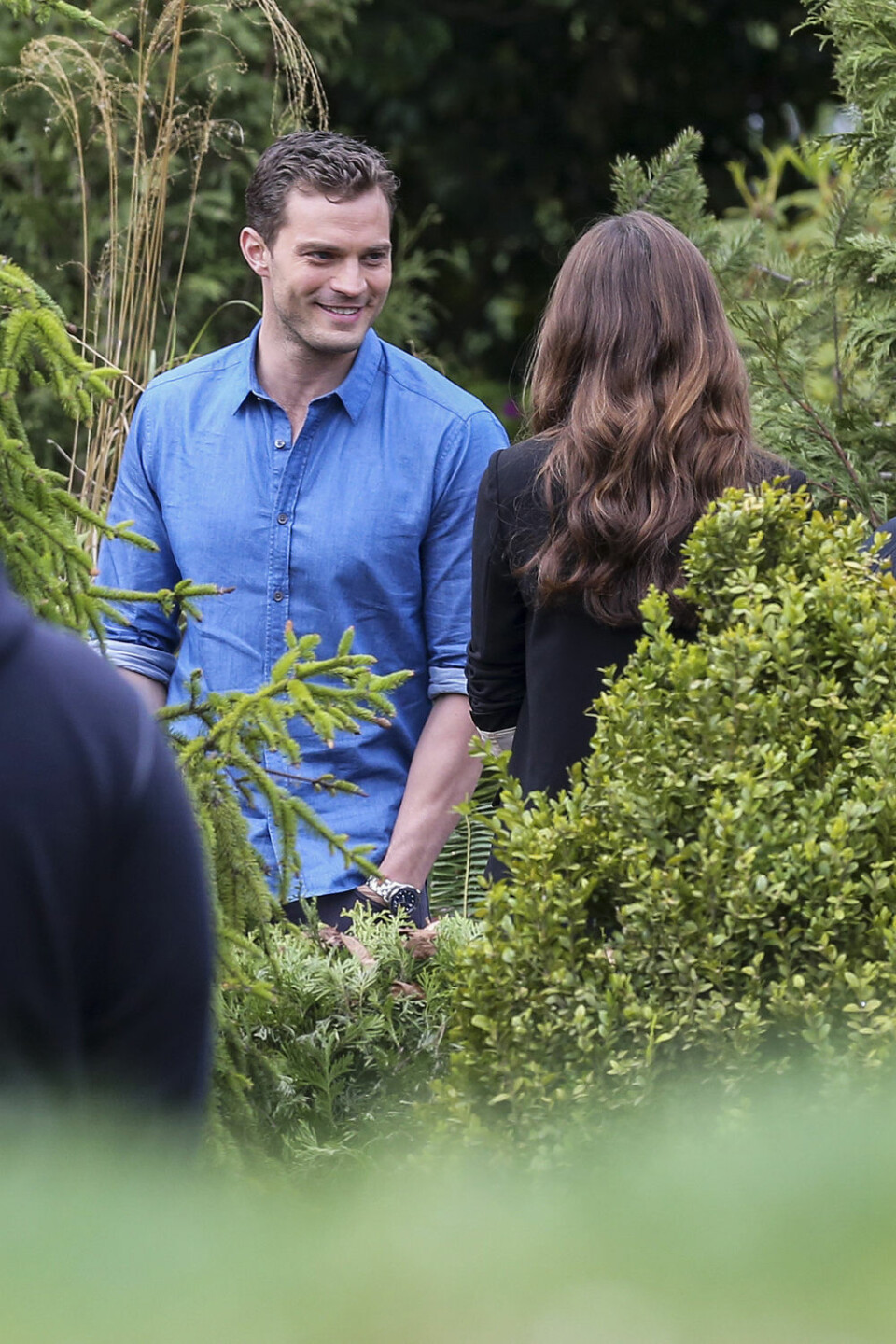 04/11/2016Dakota Johnson and Jamie Dornan spotted on The Set of Fifty Shades Darker looking quite like the couple. While frolicking through some shrubbery the two actors displayed their wedding bands through interlocking hands. Dakota was spotted in a black blazer and a low cut black skirt while co-star Jamie kept things casual in a blue button down oxford and dark blue jeans. Please byline:TheImageDirect.com IBL