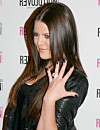 Khloé Kardashian visar upp metalliskt lila naglar.