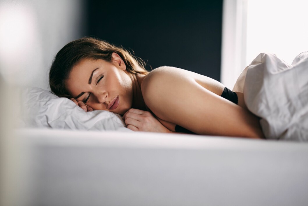 Young woman sleeping peacefully in her bed