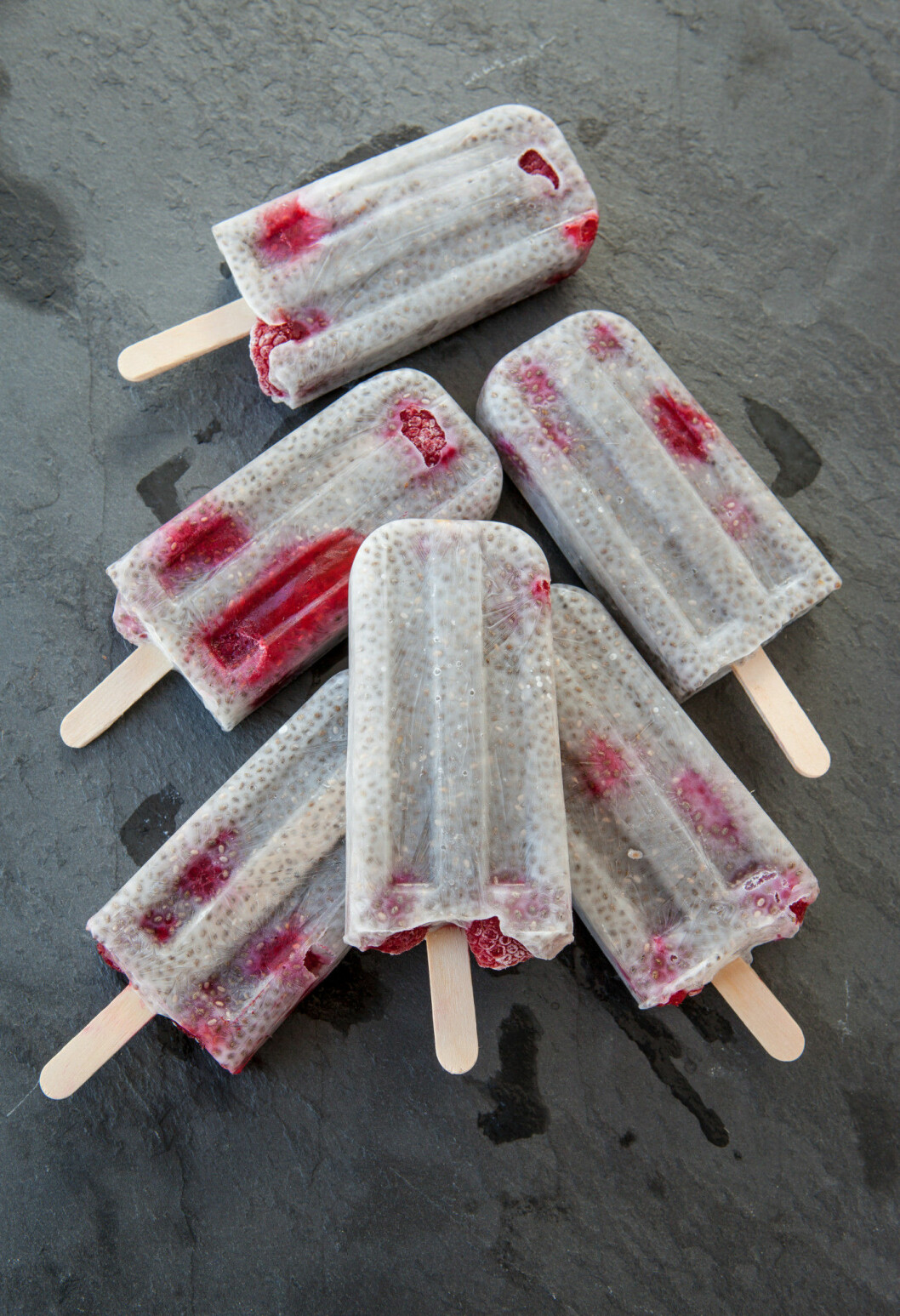 Homemade frozen popsicles with chia seeds and raspberries
