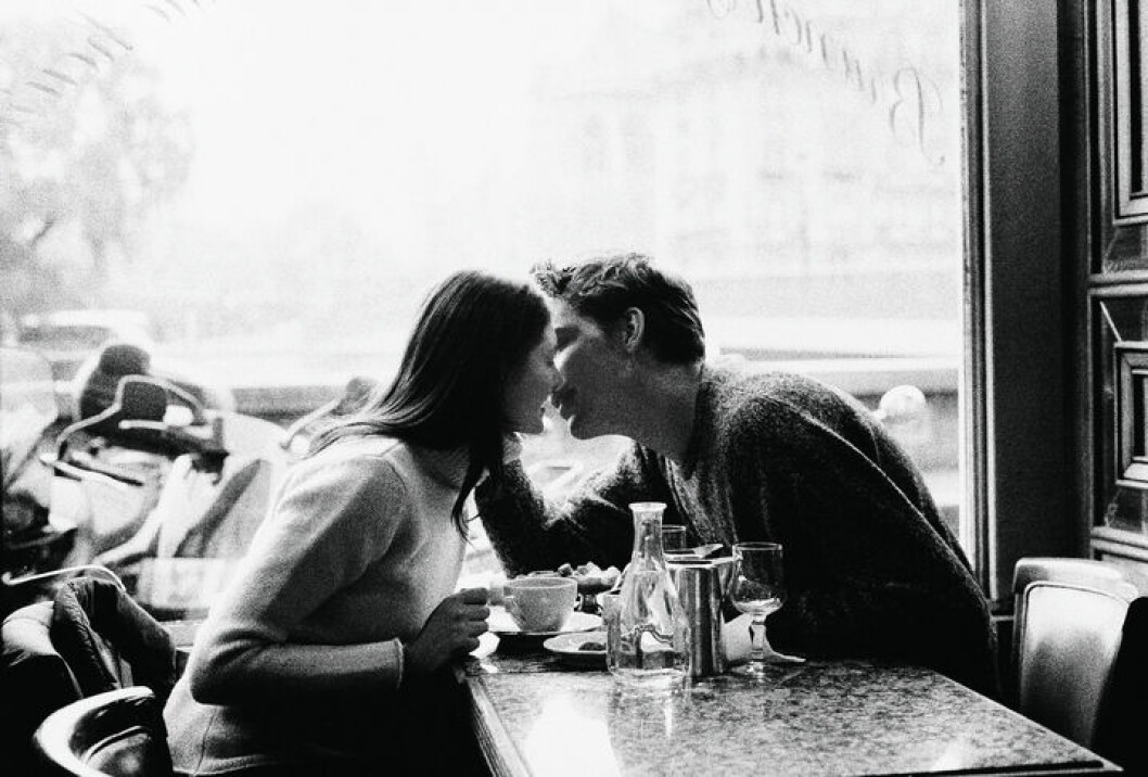 Couple kissing over coffee